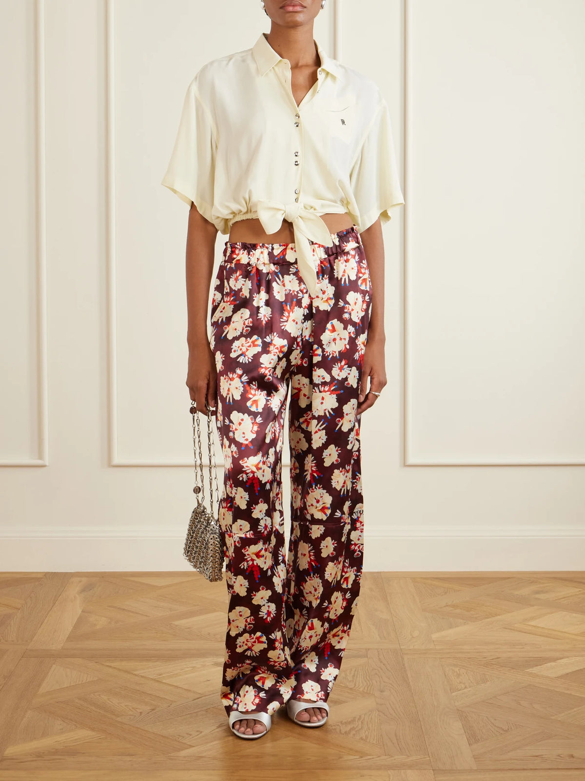 Image of a model wearing Tops. Product name - Logo-embellished Knotted Blouse in Yellow colour by brand - RABANNE
