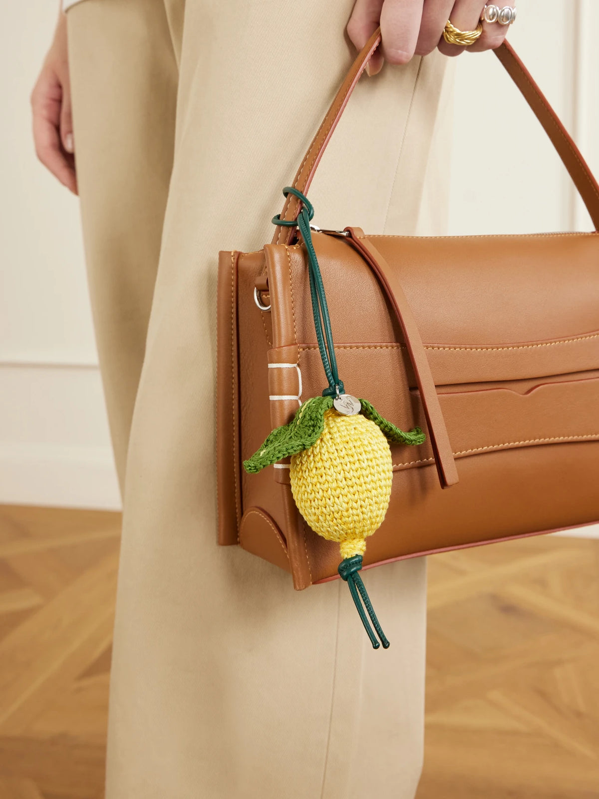 Image of Keychains. Product name - Lemon Crocheted Cotton And Leather Bag Charm in Yellow colour by brand - JW Anderson