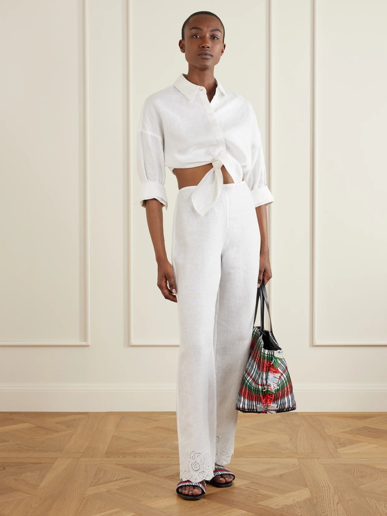 Image of a model wearing Pants. Product name - Oscar Embroidered Linen Straight-leg Pants in White colour by brand - STAUD