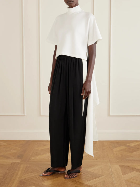 Image of a model wearing Pants. Product name - Striped Cady Straight-leg Pants in Black colour by brand - Alaïa