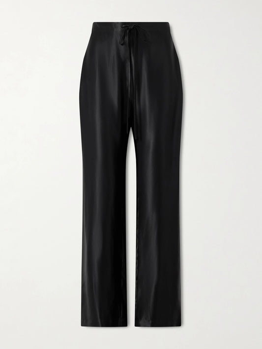 Image of a model wearing Pants. Product name - Rohen Satin Pants in Black colour by brand - KHAITE