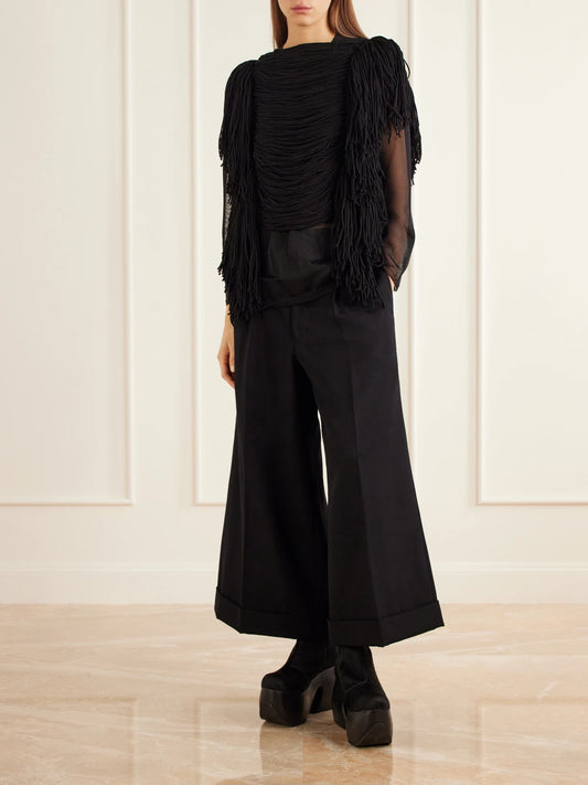 Image of a model wearing Tops. Product name - Gathered Fringed Jersey Top in Black colour by brand - Comme des Garçons