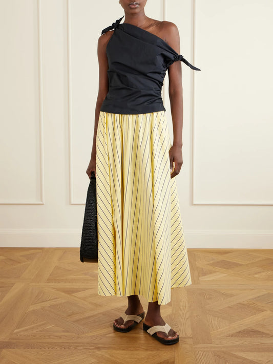 Image of a model wearing Skirts. Product name - Milano Striped Cotton-blend Maxi Skirt in Pastel yellow colour by brand - STAUD