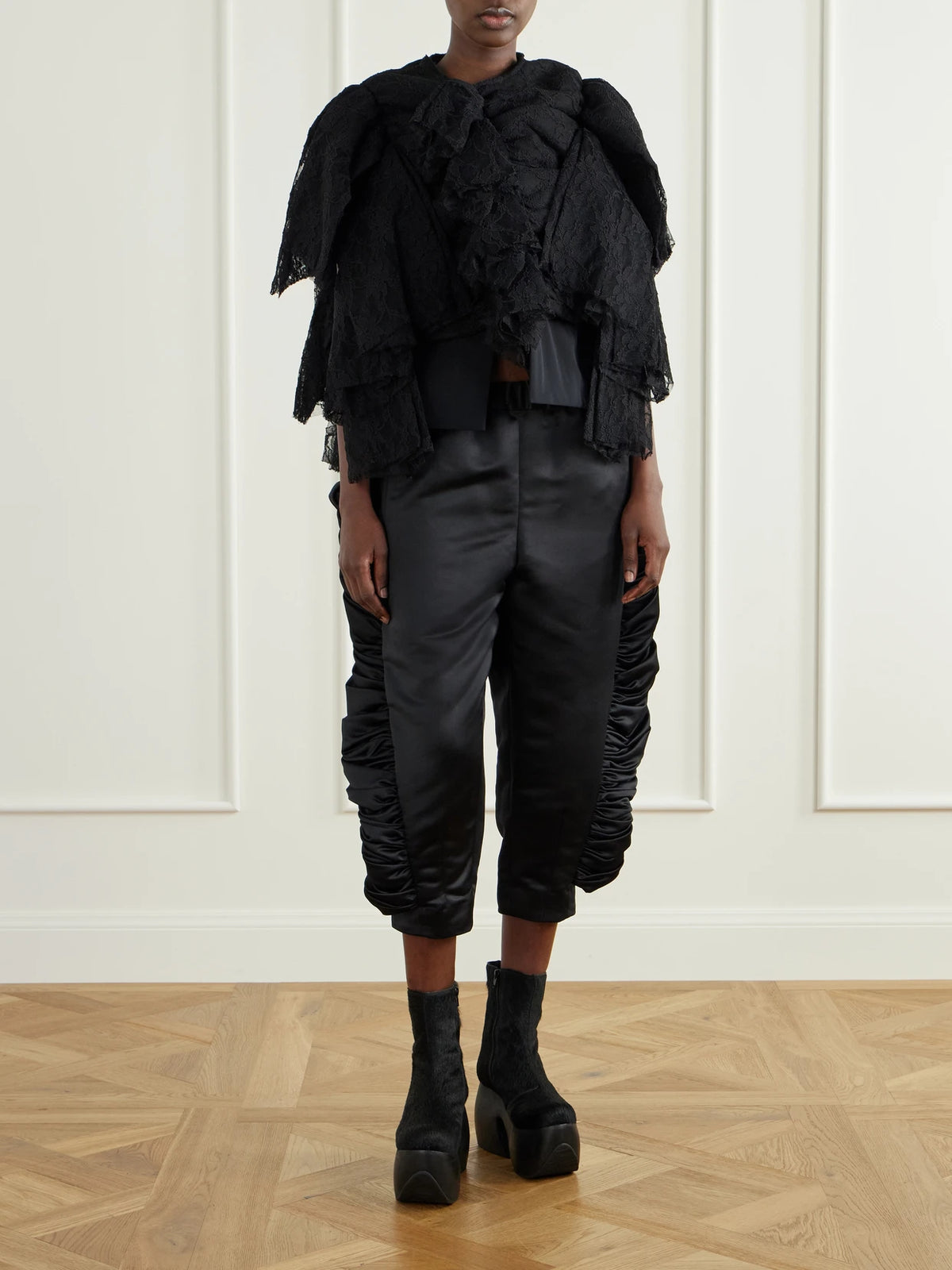 Image of a model wearing Tops. Product name - Ruffled Lace And Silk-blend Georgette Top in Black colour by brand - Comme des Garçons