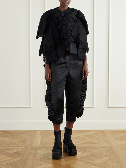 Image of a model wearing Tops. Product name - Ruffled Lace And Silk-blend Georgette Top in Black colour by brand - Comme des Garçons