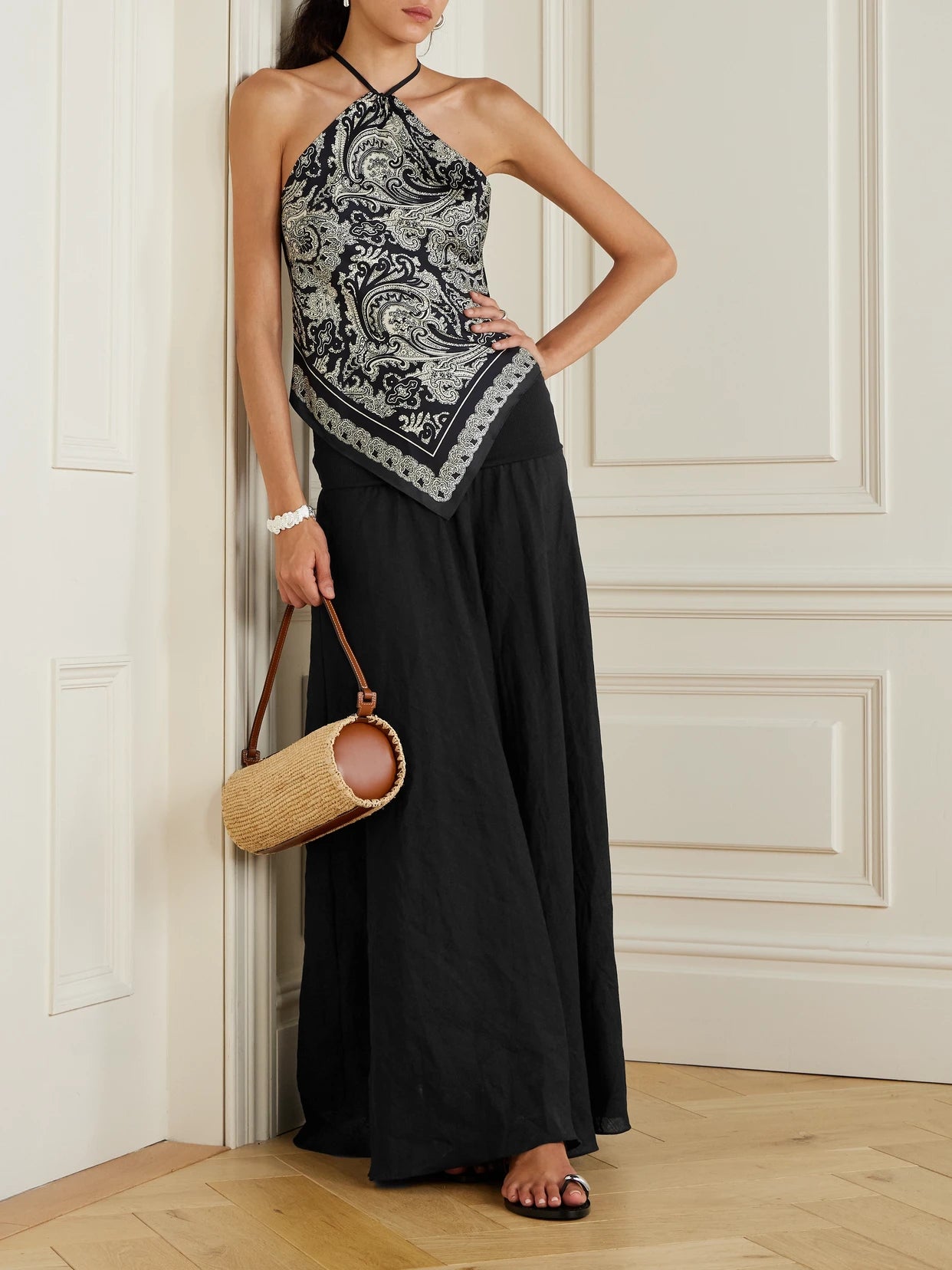Image of a model wearing Skirts. Product name - Light And Sound Convertible Linen-blend Maxi Skirt in Black colour by brand - Johanna Ortiz