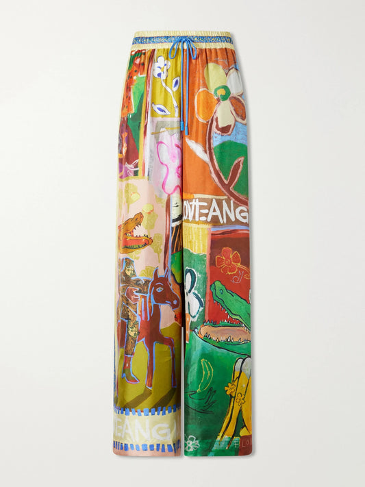 Image of a model wearing Pants. Product name - Mlak Printed Silk-twill Wide-leg Pants in Multi colour by brand - ALÉMAIS
