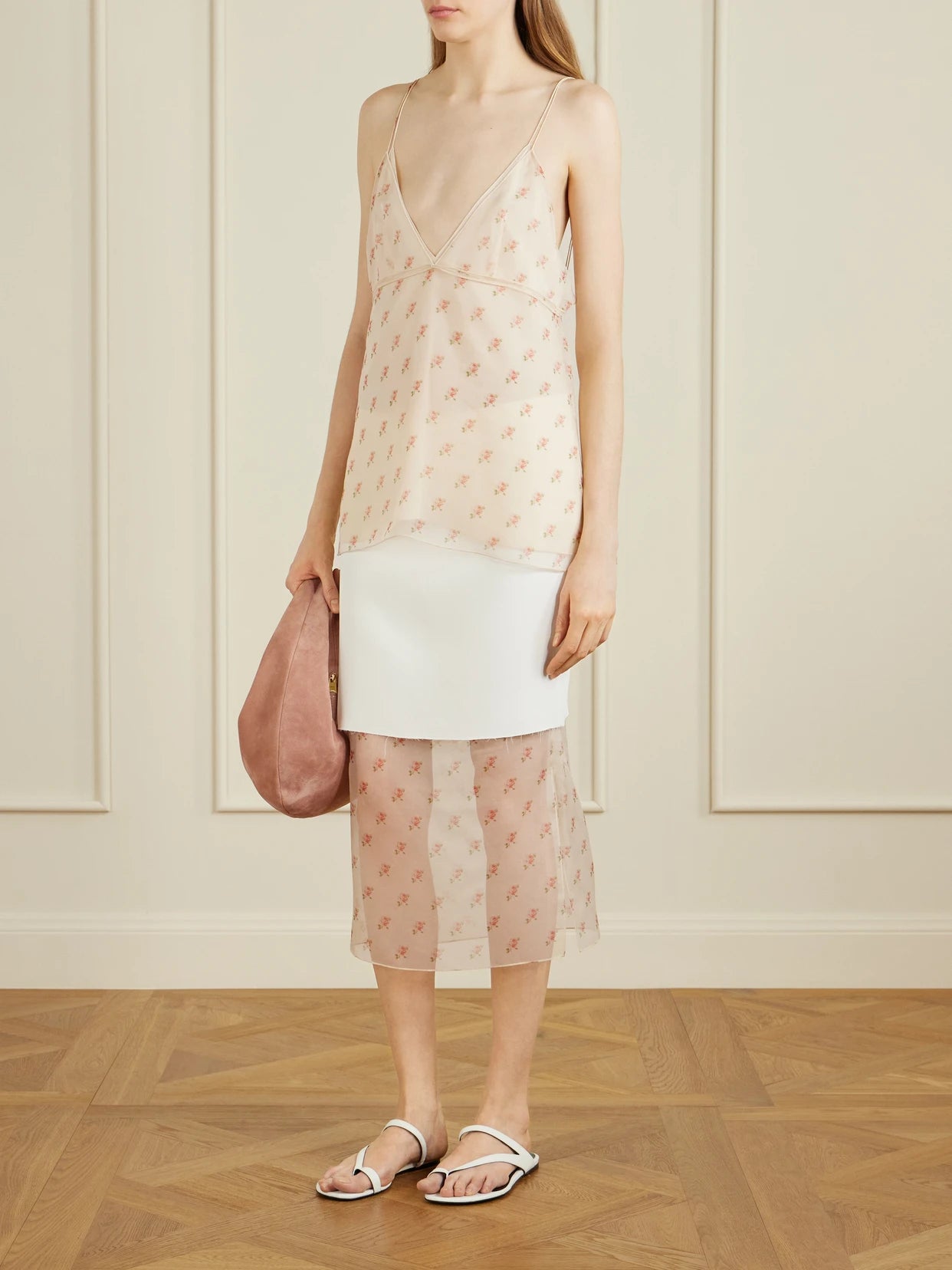 Image of a model wearing Skirts. Product name - Sybil Layered Frayed Satin-crepe And Floral-print Organza Midi Skirt in White colour by brand - KHAITE