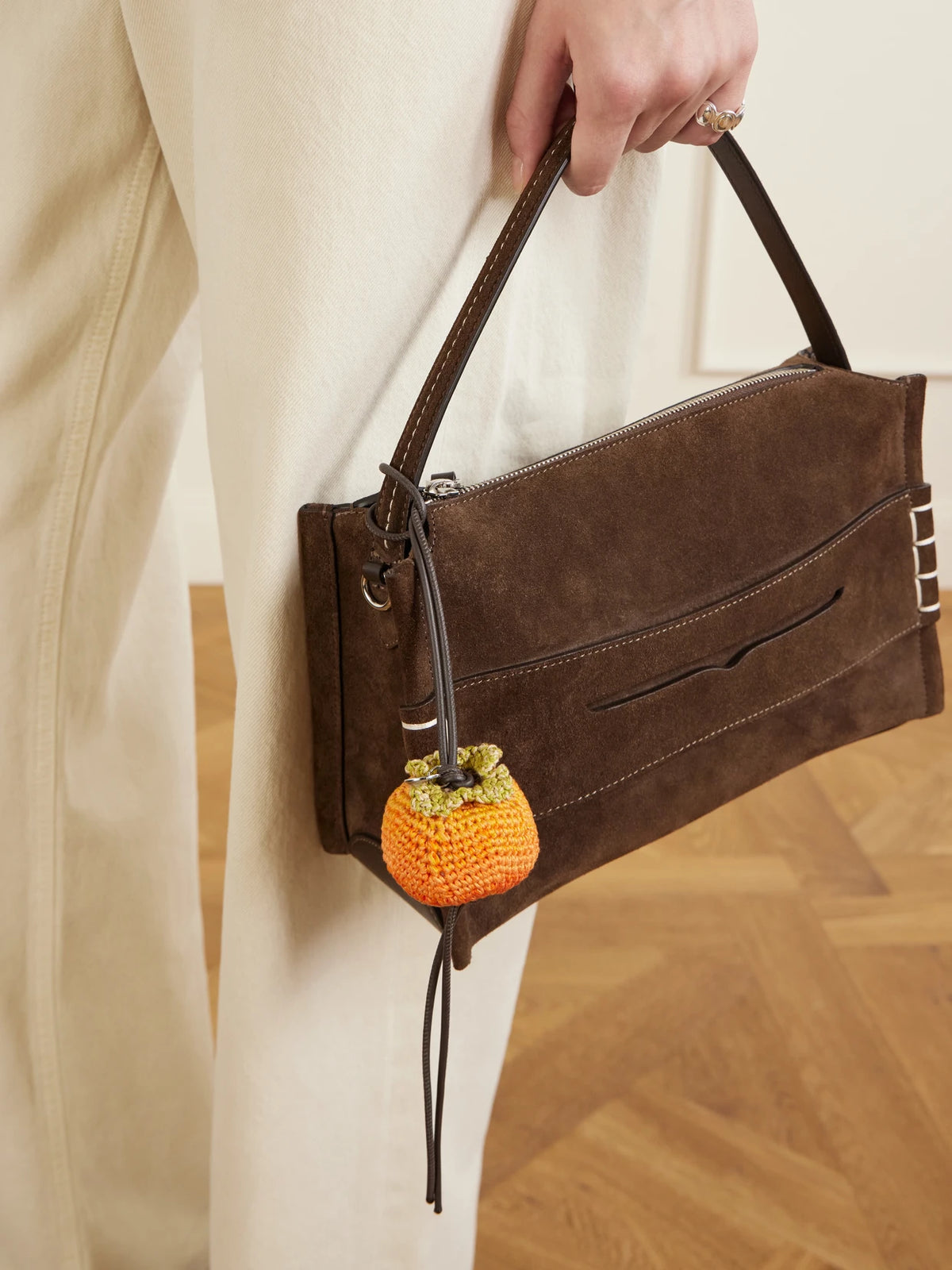 Image of Keychains. Product name - Persimmon Crocheted Cotton And Leather Bag Charm in Orange colour by brand - JW Anderson