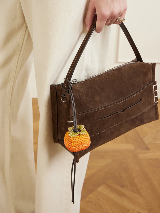 Image of Keychains. Product name - Persimmon Crocheted Cotton And Leather Bag Charm in Orange colour by brand - JW Anderson
