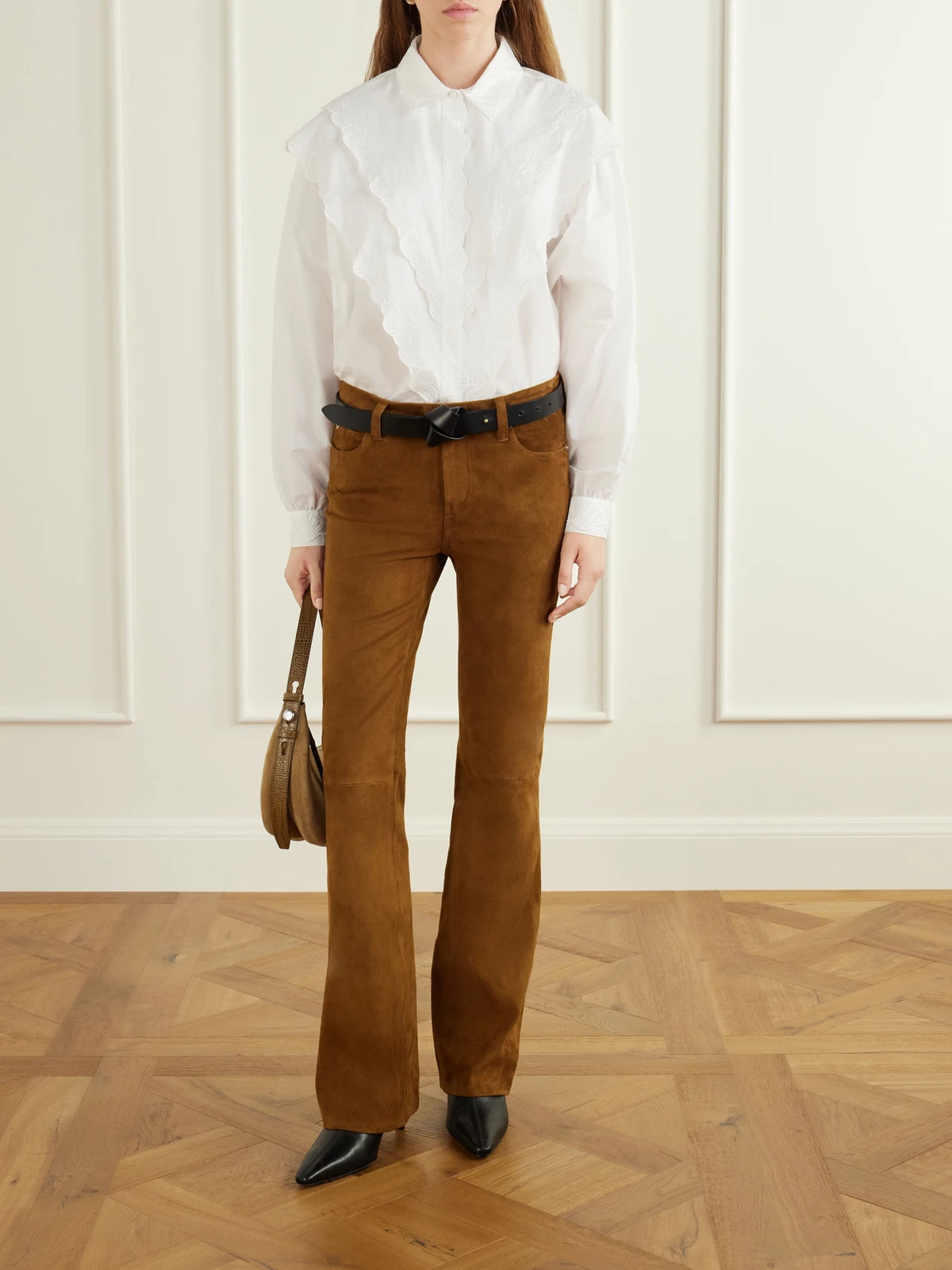 Image of a model wearing Pants. Product name - The Rodeo Suede Flared Pants in Light brown colour by brand - FRAME