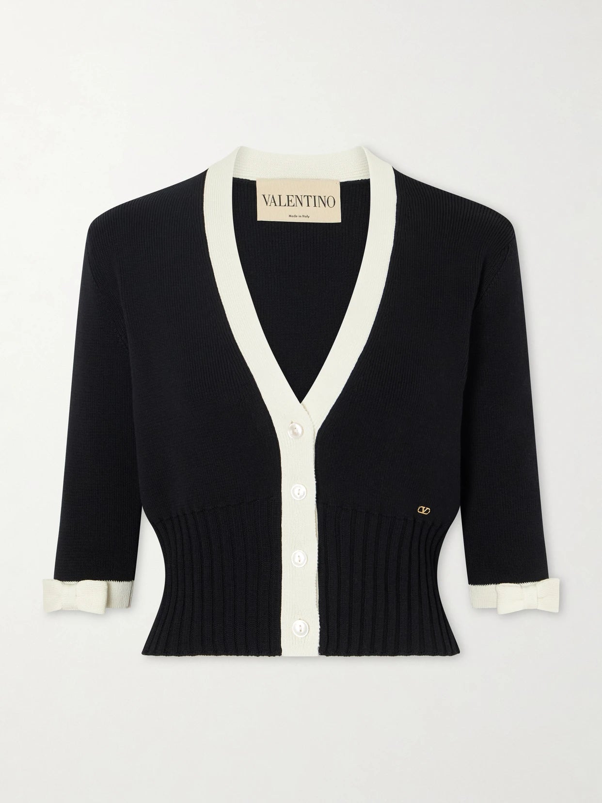 Image of a model wearing Outerwear. Product name - Cropped Bow-embellished Two-tone Ribbed-knit Cotton Cardigan in Black colour by brand - Valentino Garavani