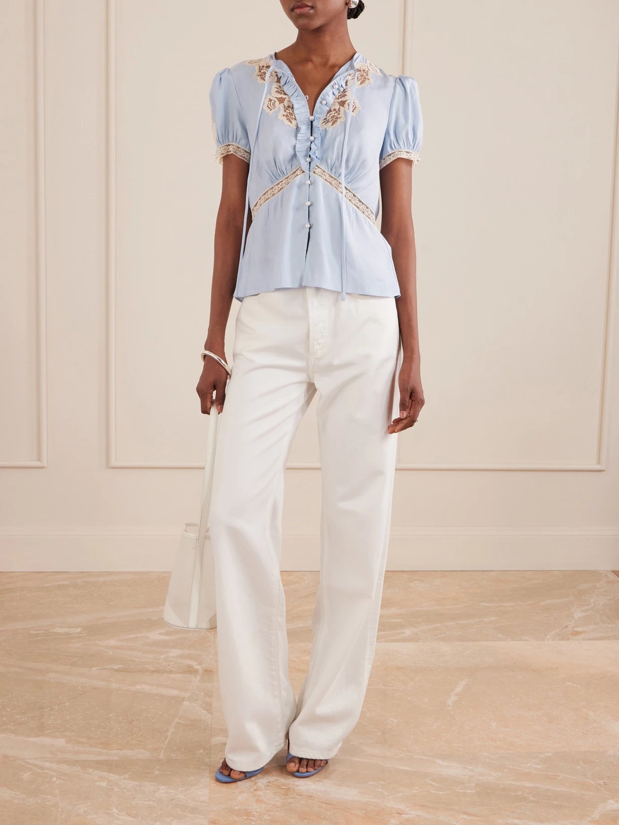 Image of a model wearing Tops. Product name - Ruffled Lace-trimmed Satin Blouse in Blue colour by brand - Self-Portrait