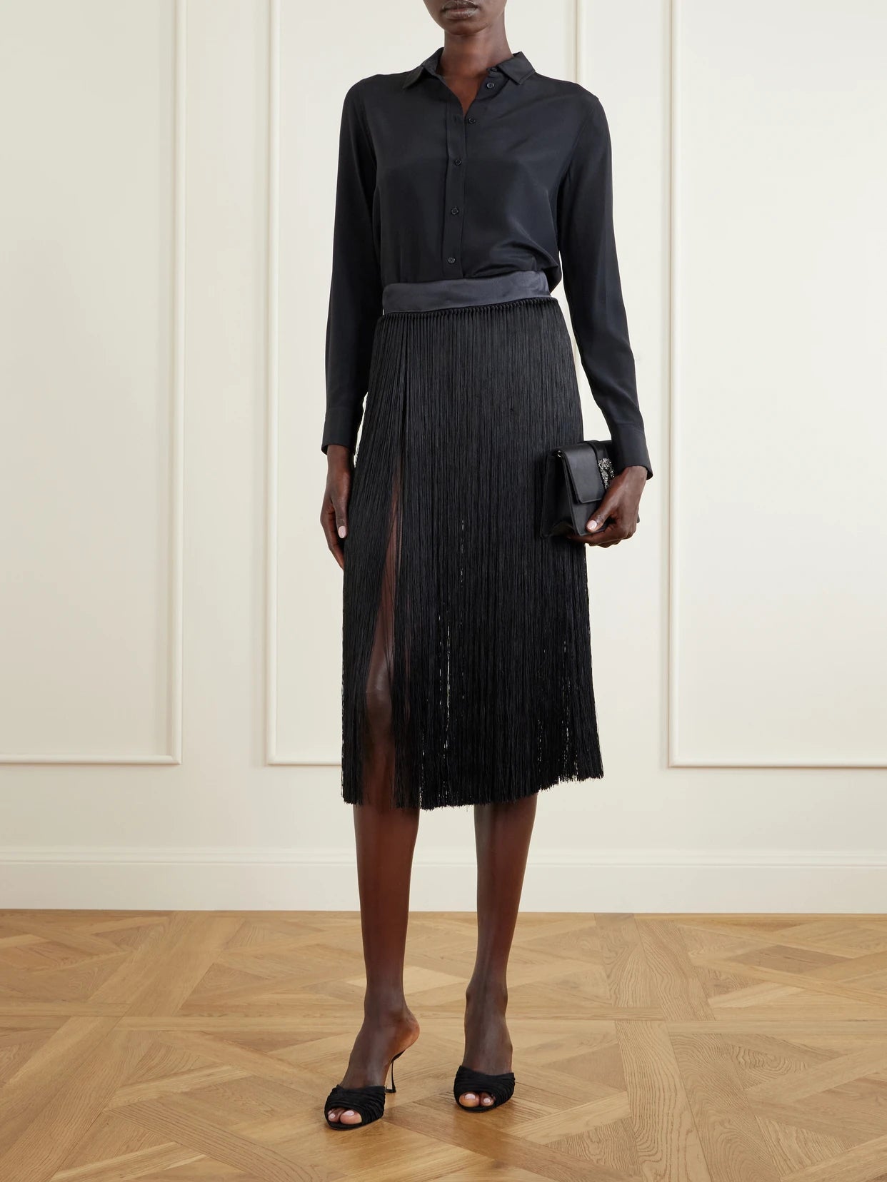 Image of a model wearing Skirts. Product name - Fringed Midi Skirt in Black colour by brand - Dolce & Gabbana