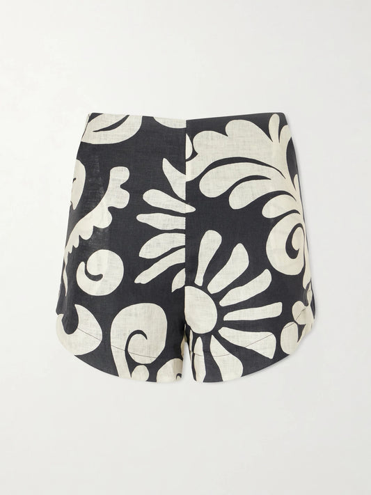 Image of a model wearing Shorts. Product name - Bahamas Printed Linen Shorts in Black colour by brand - Cala de la Cruz