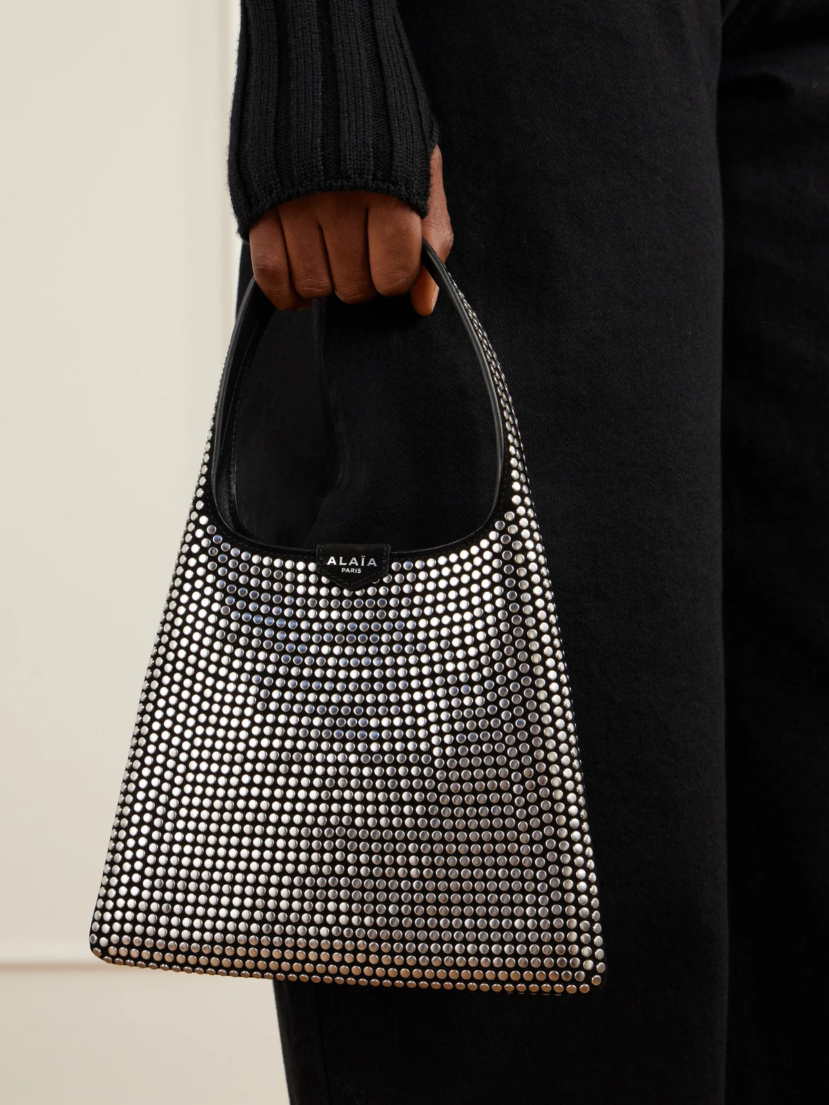 Image of Bags. Product name - Studded Leather-trimmed Suede Shoulder Bag in Black colour by brand - Alaïa