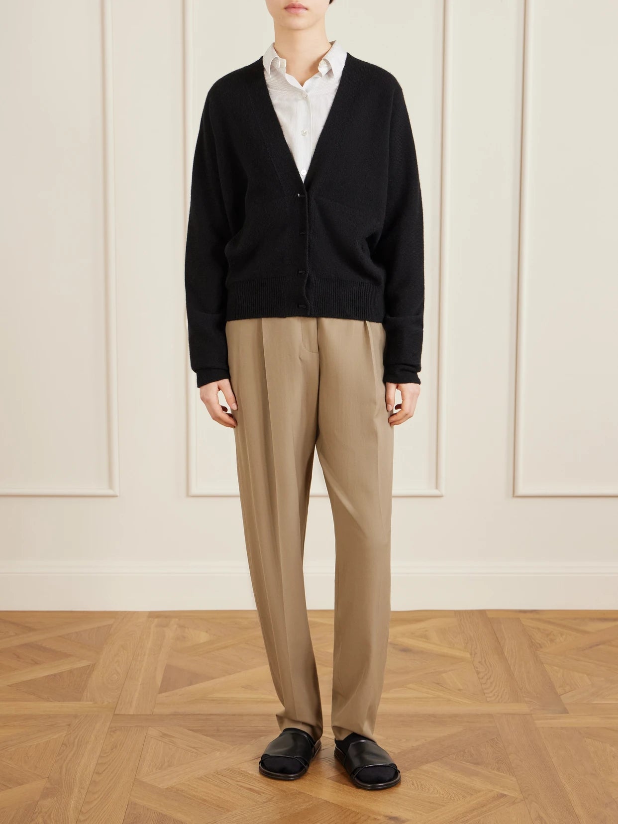 Image of a model wearing Pants. Product name - Gianni Pleated Wool Pants in Beige colour by brand - The Row