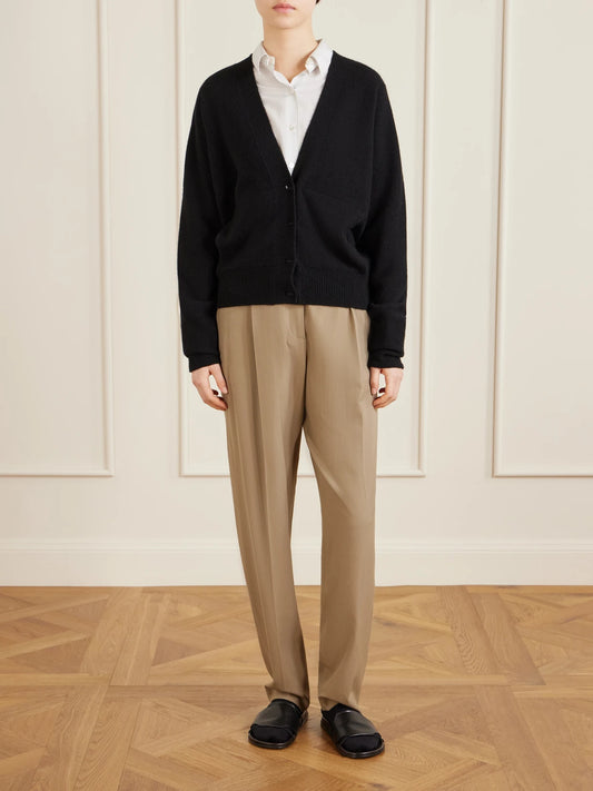 Image of a model wearing Pants. Product name - Gianni Pleated Wool Pants in Beige colour by brand - The Row