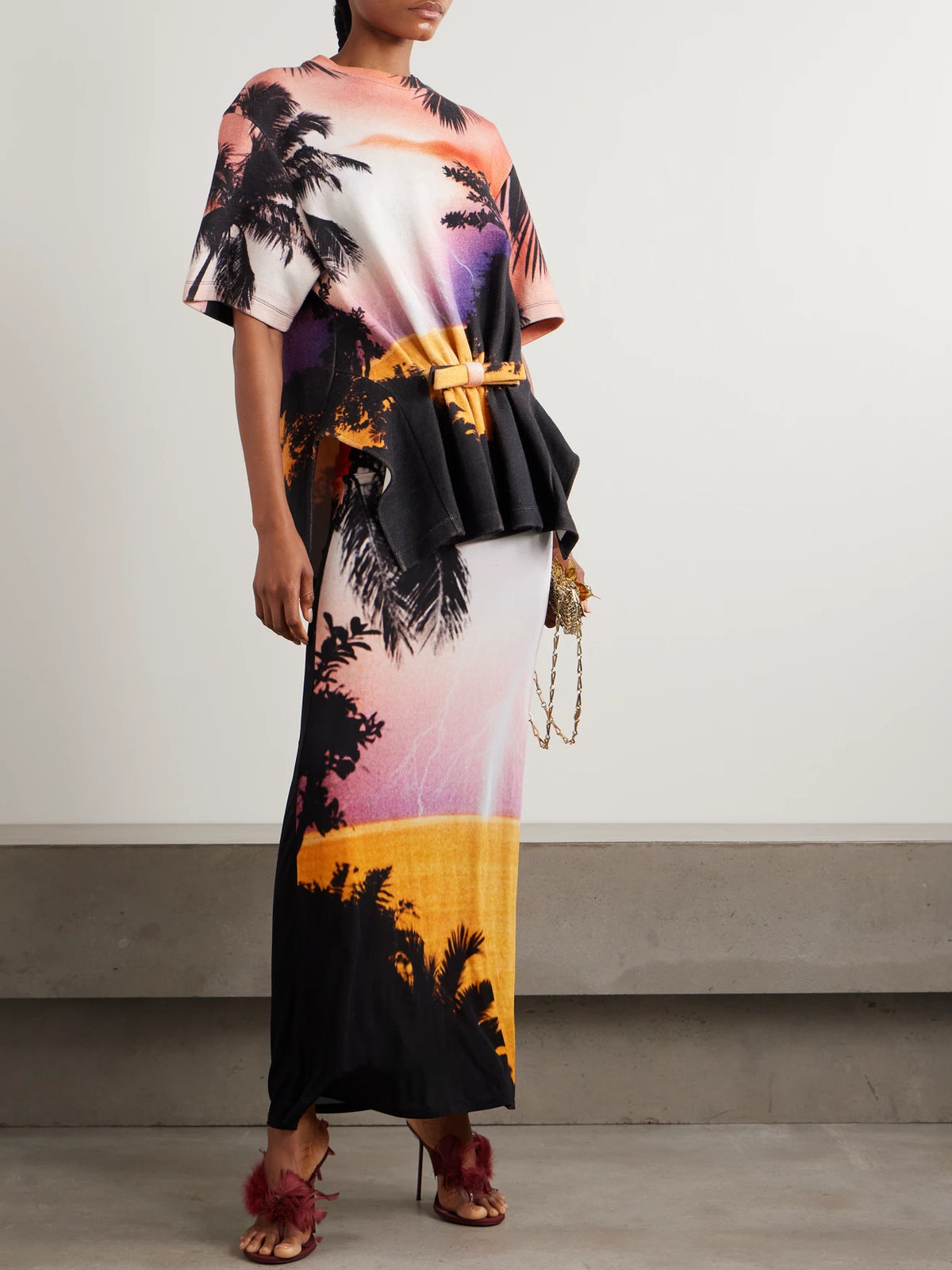 Image of a model wearing Tops. Product name - Bow-detailed Printed Gathered Jersey T-shirt in Multi colour by brand - RABANNE