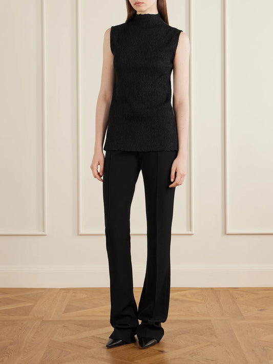 Image of a model wearing Outerwear. Product name - Oakson Silk Plissé Turleneck Sweater in Black colour by brand - The Row
