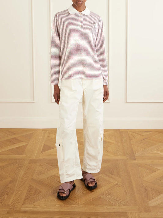 Image of a model wearing Tops. Product name - Trust Logo-embroidered Striped Cotton And Linen-blend Polo T-shirt in Pink colour by brand - Wales Bonner