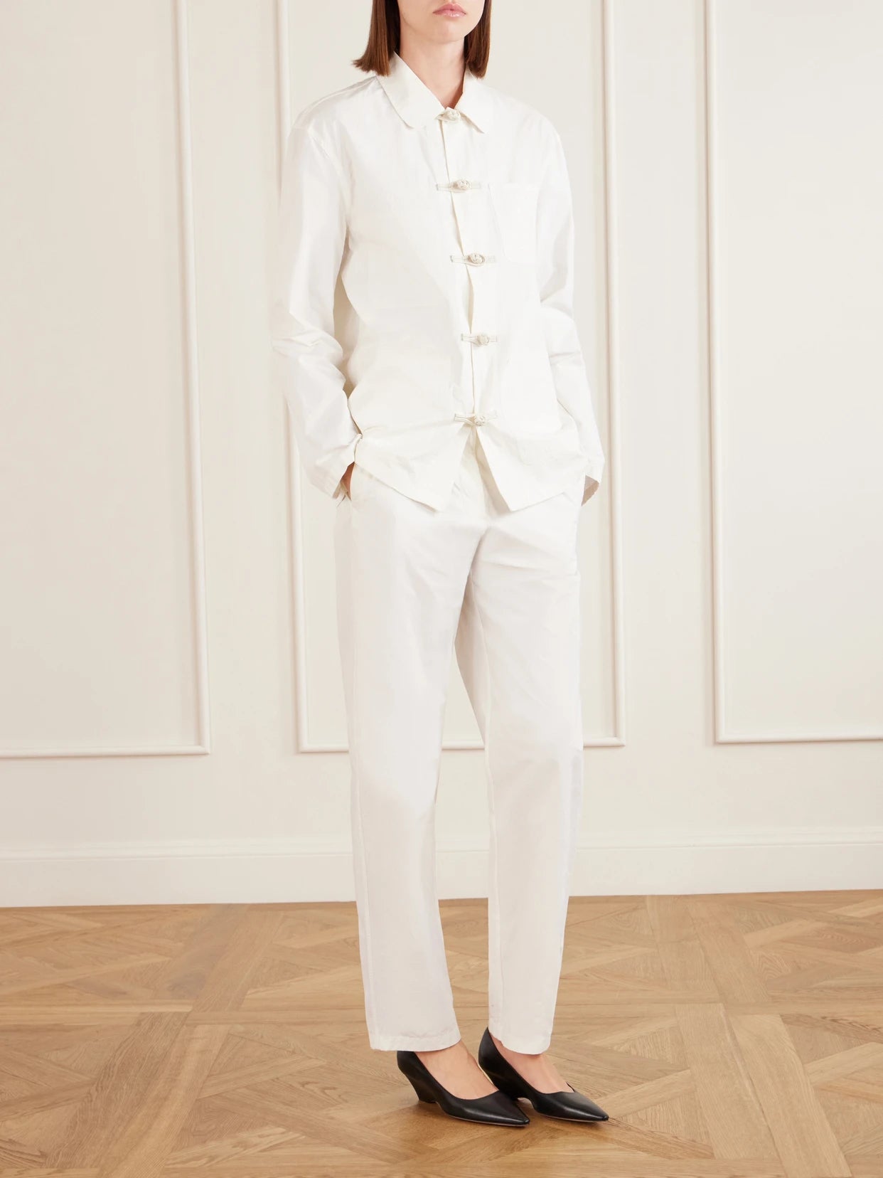 Image of a model wearing Pants. Product name - Fael Cotton-poplin Straight-leg Pants in White colour by brand - The Row