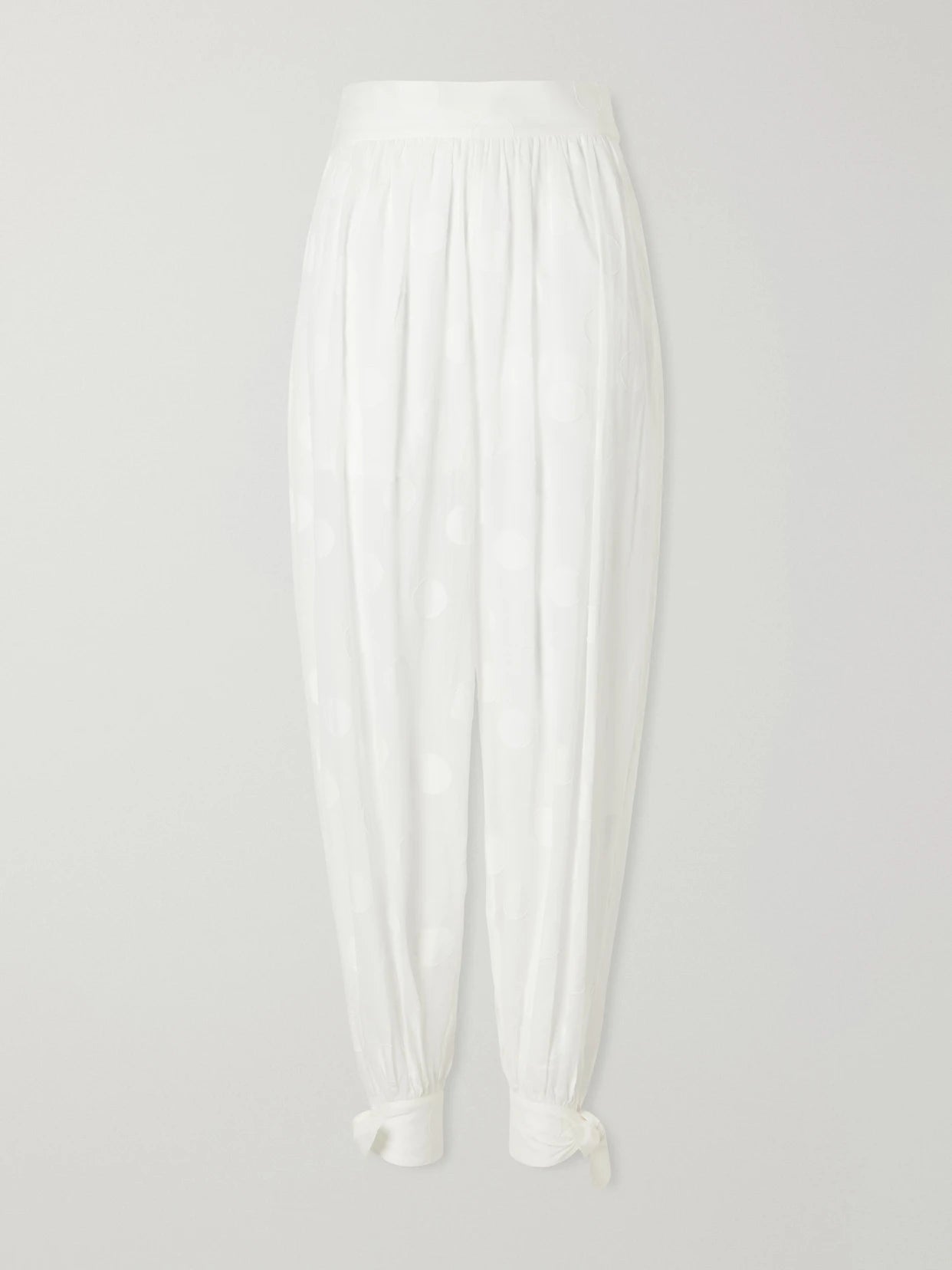 Image of a model wearing Pants. Product name - Solstice Knotted Polka-dot Cotton-poplin Balloon Pants in Ivory colour by brand - Zimmermann