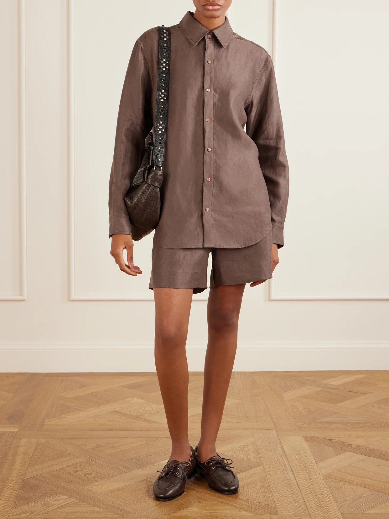 Image of a model wearing Shorts. Product name - Cocoa Cropped Linen Shorts in Brown colour by brand - God's True Cashmere