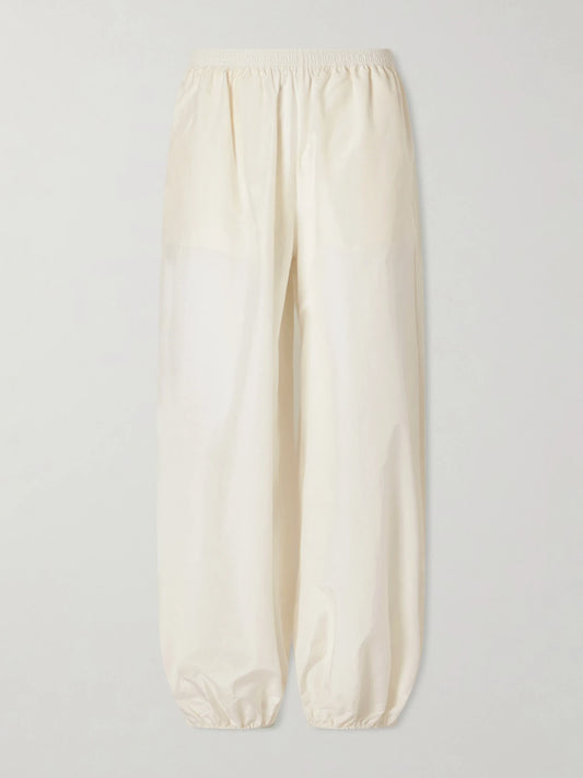 Image of a model wearing Pants. Product name - Almaya Cotton And Silk-blend Balloon Pants in Ivory colour by brand - Loulou de Saison