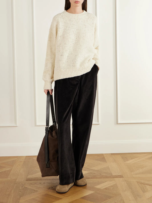 Image of a model wearing Outerwear. Product name - Maele Bouclé Merino Wool-blend Sweater in Cream colour by brand - Studio Nicholson