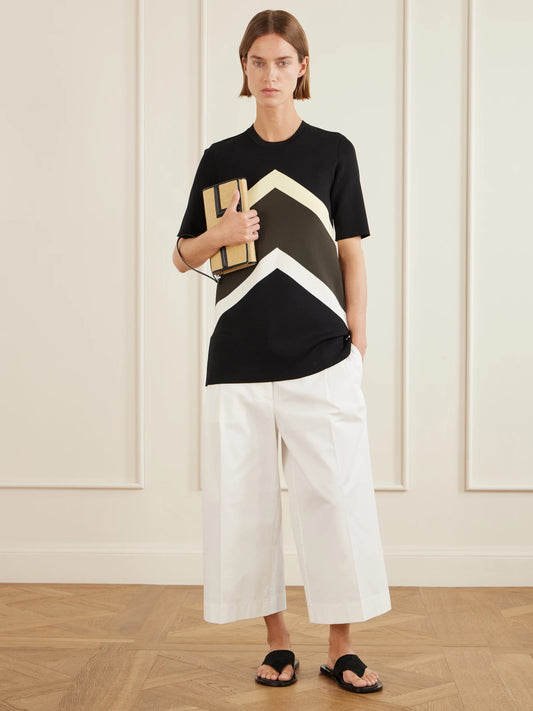 Image of a model wearing Tops. Product name - Striped Jersey T-shirt in Black colour by brand - TOTEME