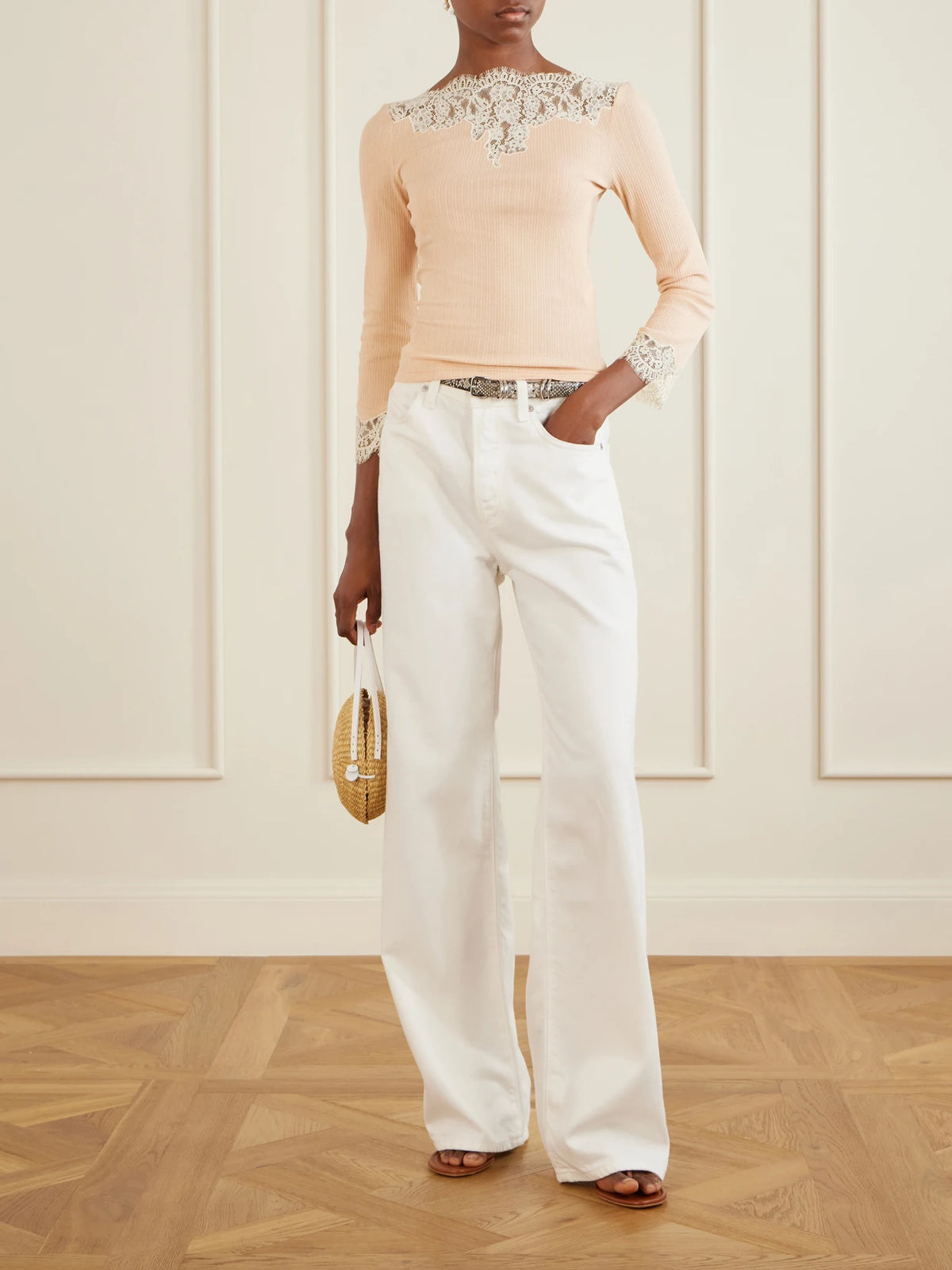 Image of a model wearing Tops. Product name - Riana Lace-trimmed Cotton-blend Jersey T-shirt in Cream colour by brand - DÔEN