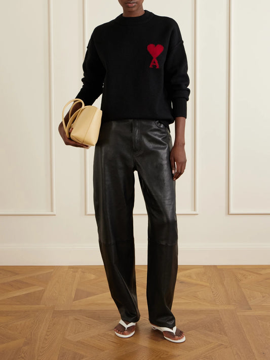 Image of a model wearing Outerwear. Product name - Intarsia Wool Sweater in Black colour by brand - AMI PARIS