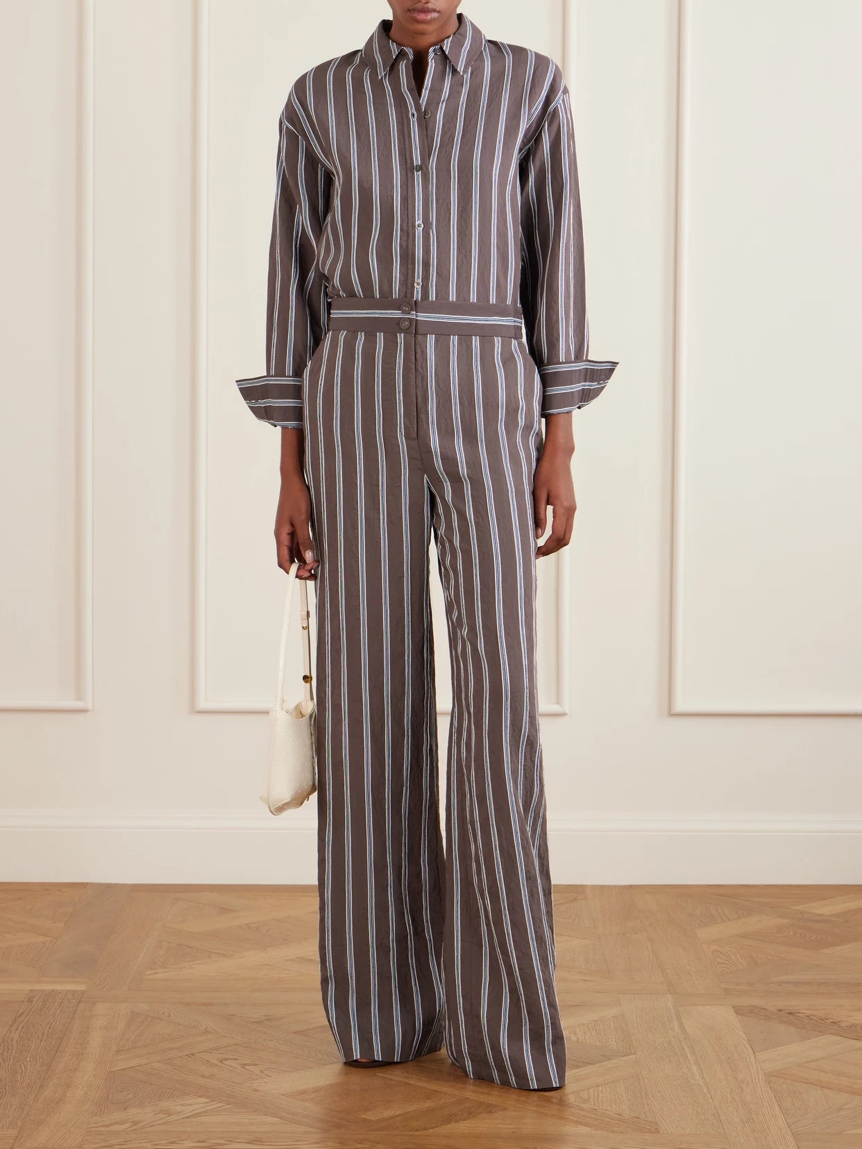 Image of a model wearing Tops. Product name - Lloyd Striped Woven Shirt in Dark brown colour by brand - Veronica Beard
