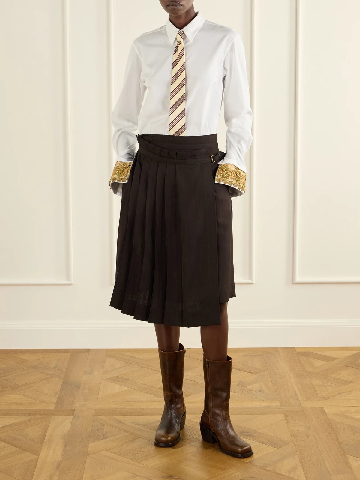 Image of a model wearing Skirts. Product name - Striped Pleated Twill Knee-length Skirt in Dark brown colour by brand - Dries Van Noten