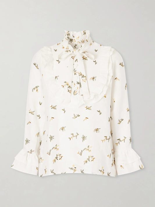 Image of a model wearing Tops. Product name - Valeria Ruffled Embroidered Linen Blouse in White colour by brand - Cristiano Marcheli