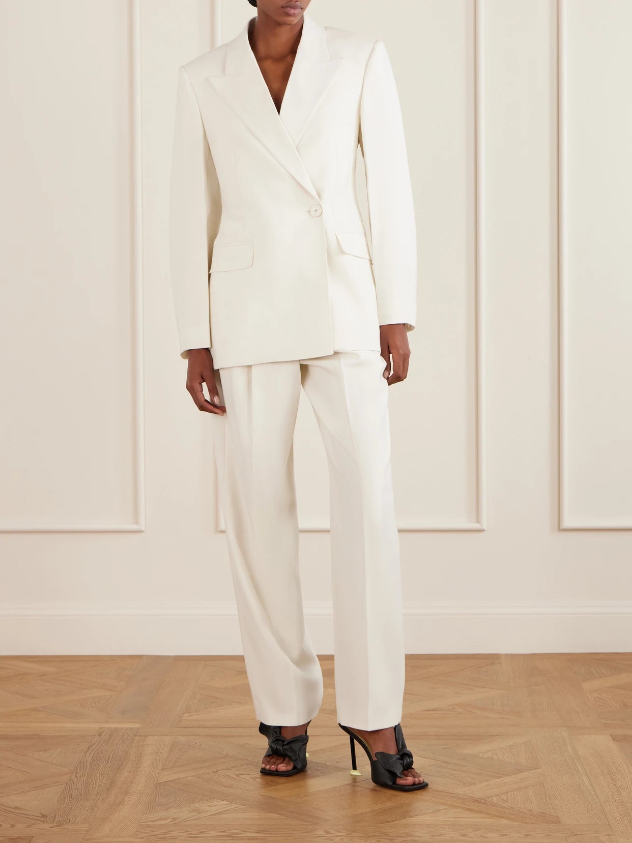 Image of a model wearing Pants. Product name - Pleated Grain De Poudre Wool And Mohair-blend Wide-leg Pants in White colour by brand - Givenchy