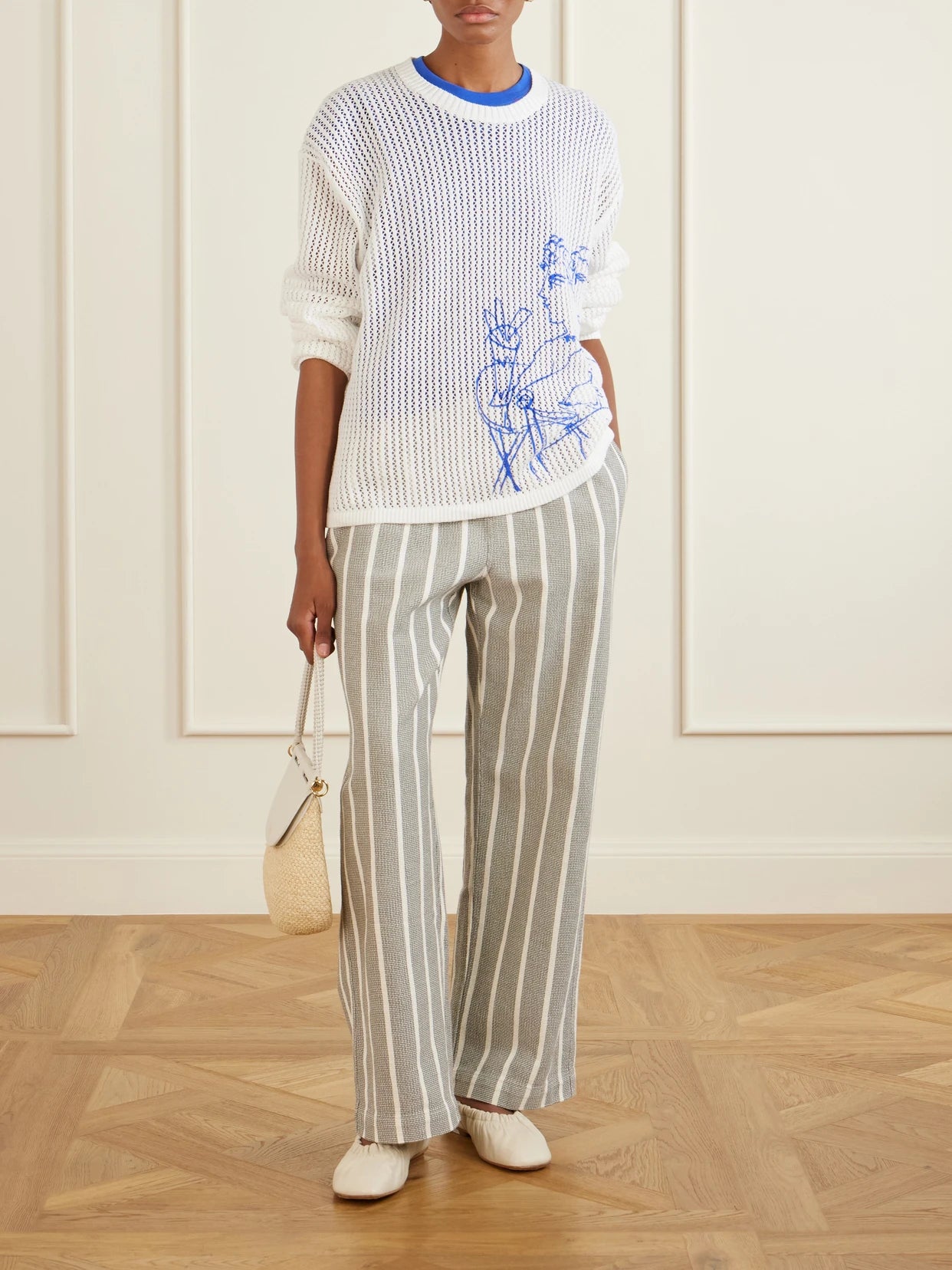 Image of a model wearing Pants. Product name - Striped-print Cotton Canvas Wide-leg Pants in Gray colour by brand - Aimé Leon Dore