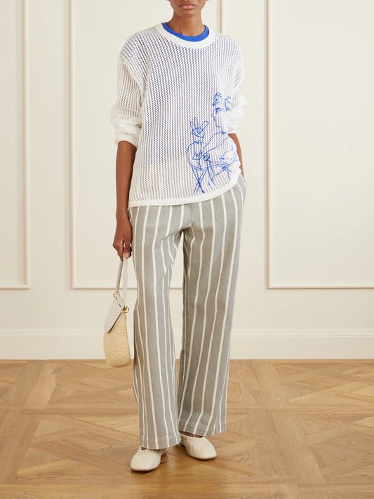 Image of a model wearing Pants. Product name - Striped-print Cotton Canvas Wide-leg Pants in Gray colour by brand - Aimé Leon Dore