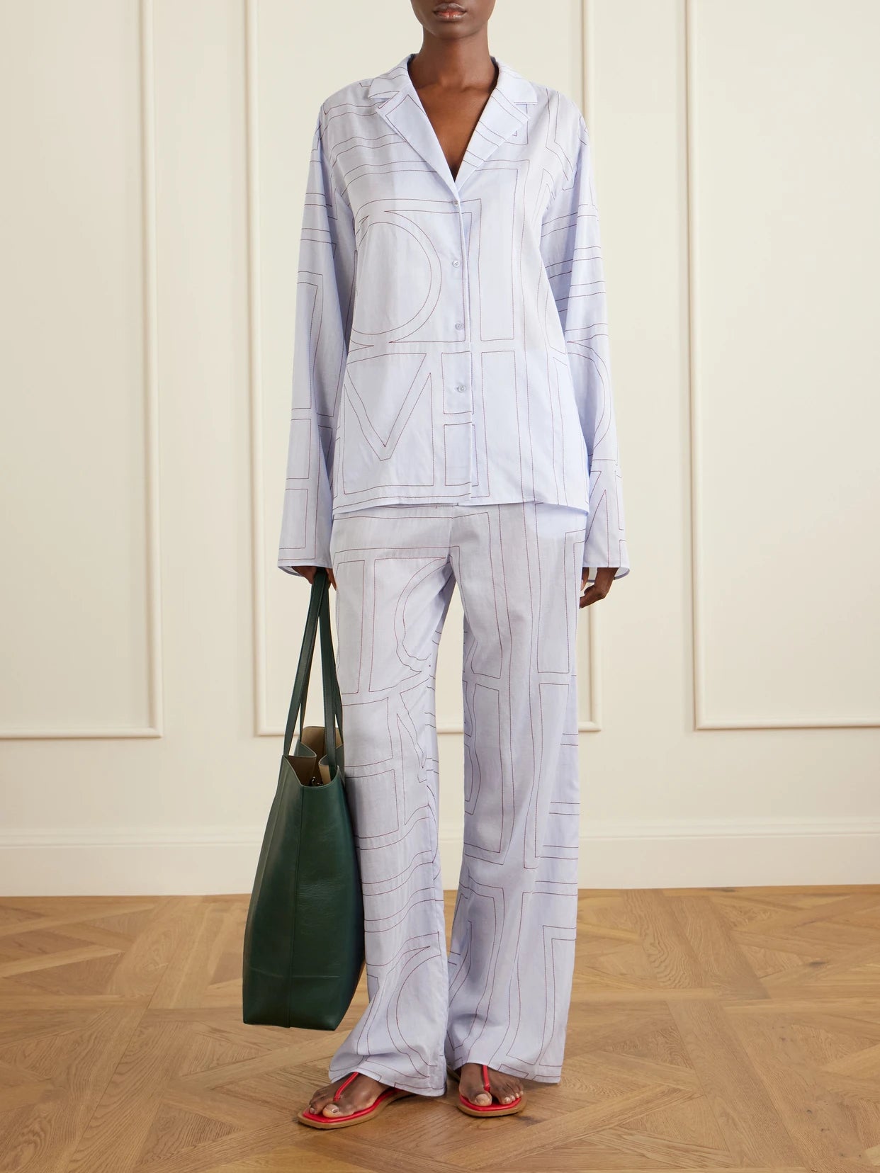 Image of a model wearing Tops. Product name - Embroidered Cotton And Lyocell-blend Shirt in Light blue colour by brand - TOTEME