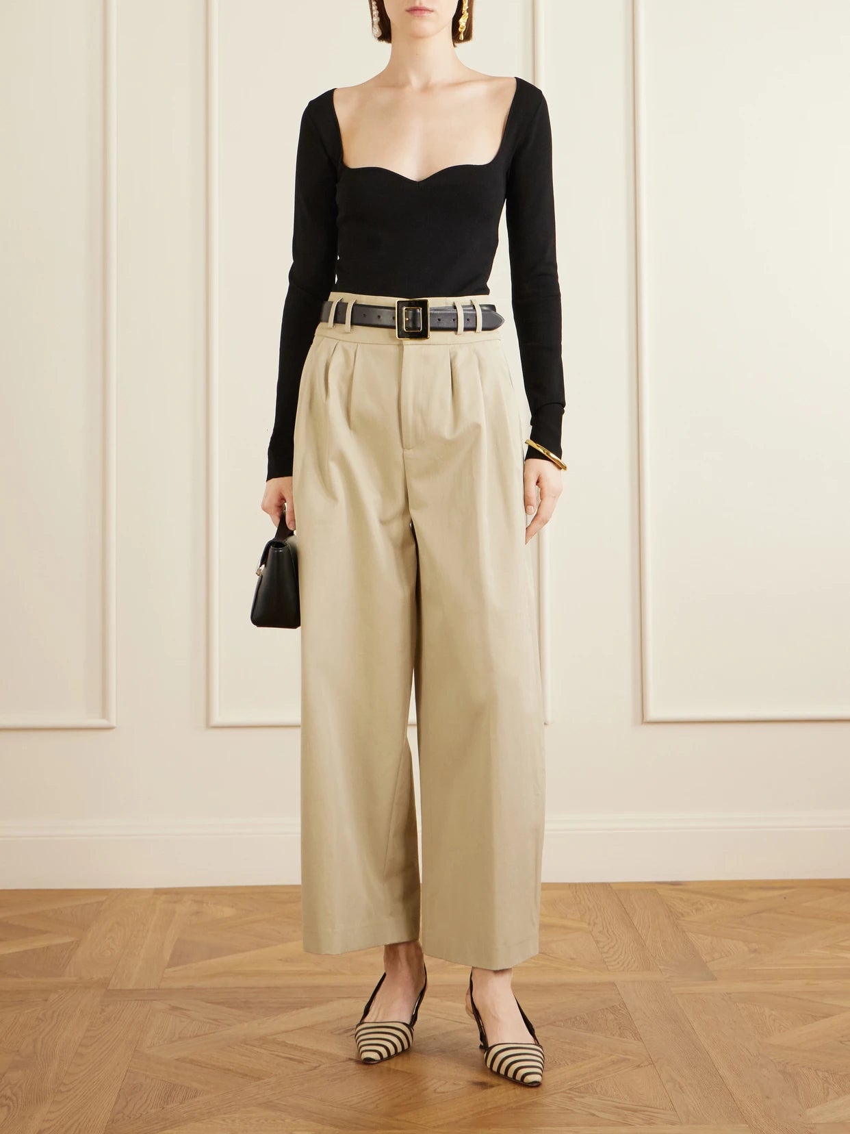 Image of a model wearing Pants. Product name - Wilson Pleated Wide-leg Cotton Pants in Beige colour by brand - Altuzarra