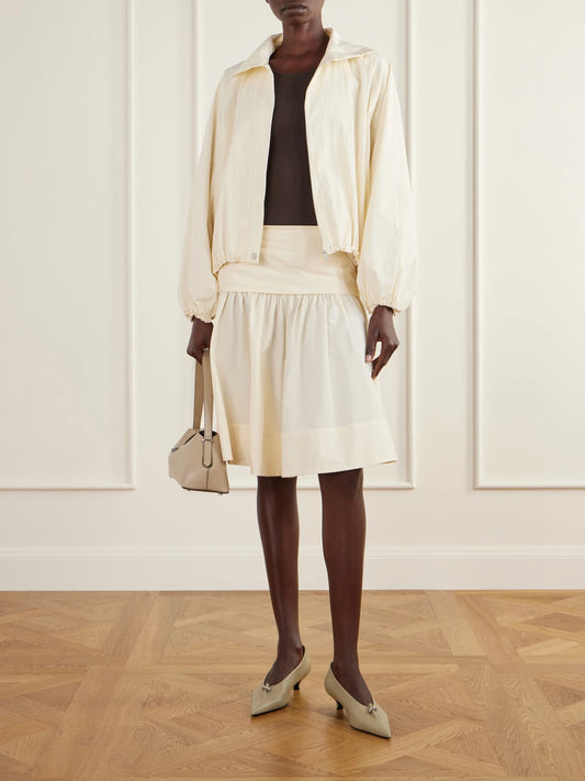 Image of a model wearing Skirts. Product name - Gathered Cotton-poplin Knee-length Skirt in Cream colour by brand - ST. AGNI