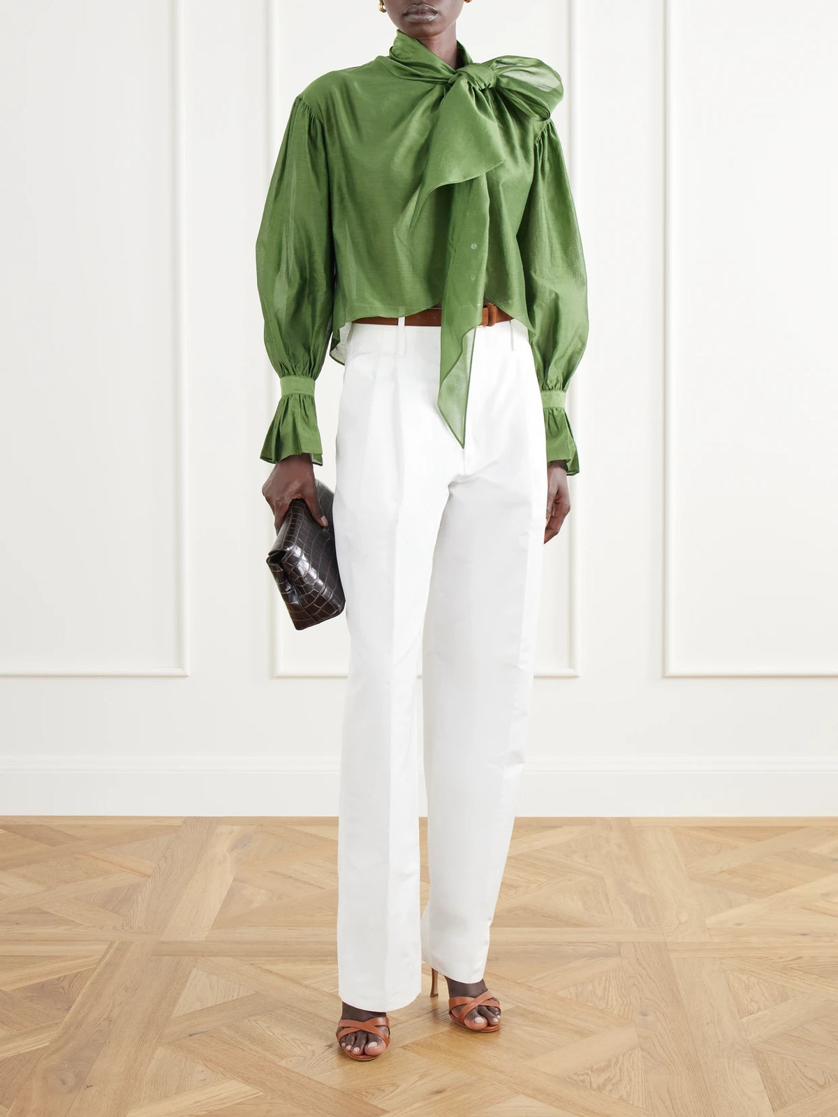 Image of a model wearing Tops. Product name - Bow-detailed Asymmetric Cotton And Silk-blend Organdy Blouse in Green colour by brand - Polo Ralph Lauren