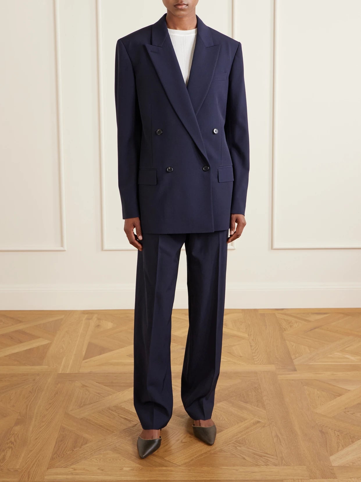 Image of a model wearing Outerwear. Product name - Paden Double-breasted Wool Blazer in Navy colour by brand - The Row