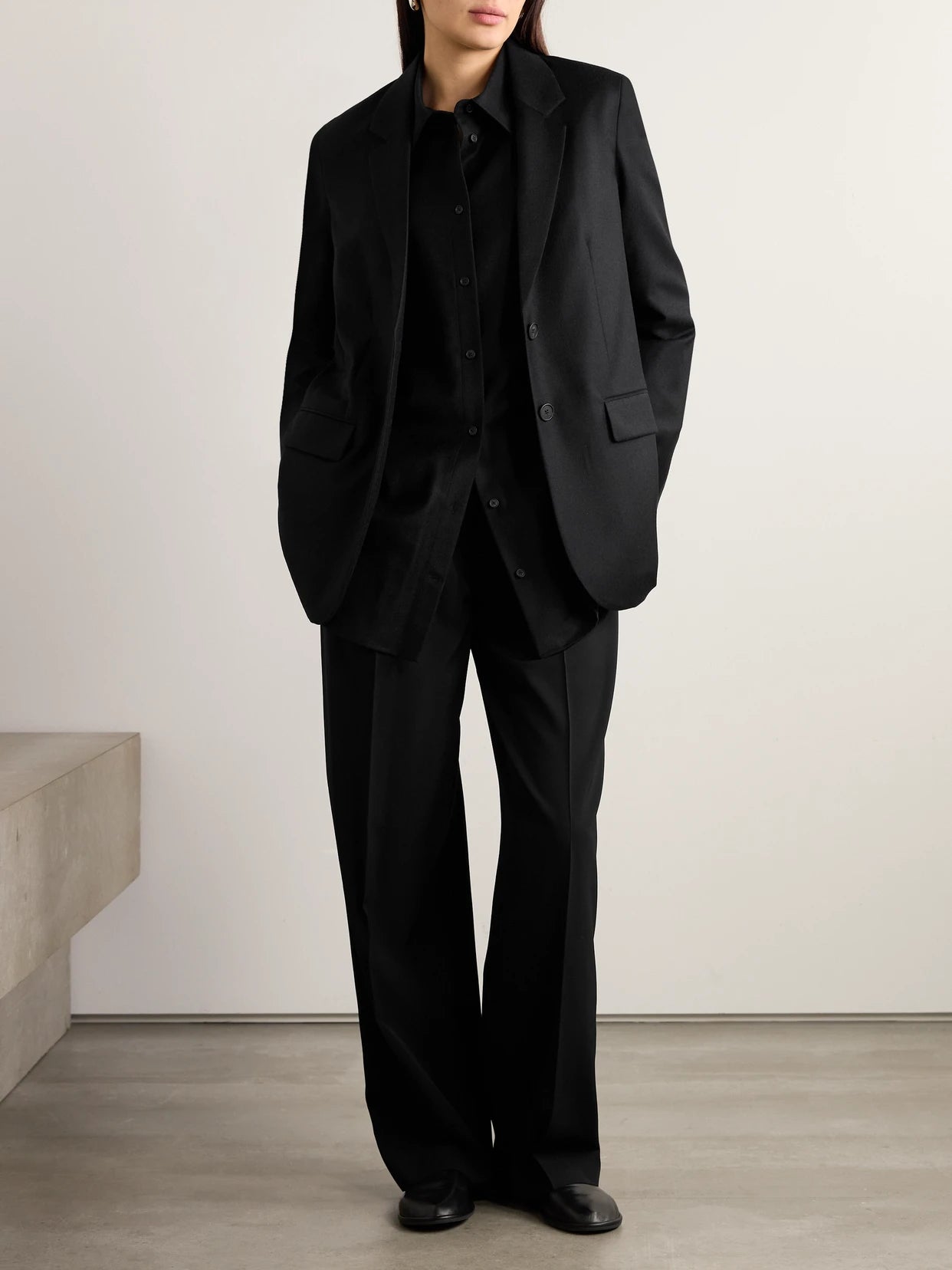 Image of a model wearing Tops. Product name - Essentials Caroline Oversized Wool Shirt in Black colour by brand - The Row