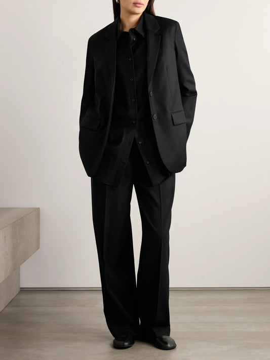 Image of a model wearing Tops. Product name - Essentials Caroline Oversized Wool Shirt in Black colour by brand - The Row