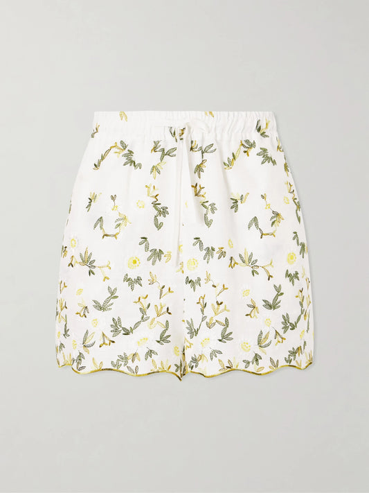 Image of a model wearing Shorts. Product name - Elena Floral-embroidered Linen Drawstring Shorts in White colour by brand - Cristiano Marcheli