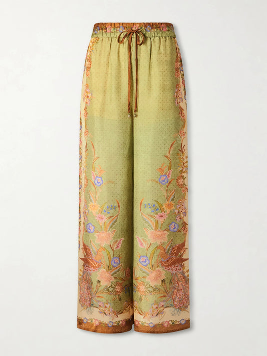 Image of a model wearing Pants. Product name - Indra Printed Silk Wide-leg Pants in Green colour by brand - Zimmermann