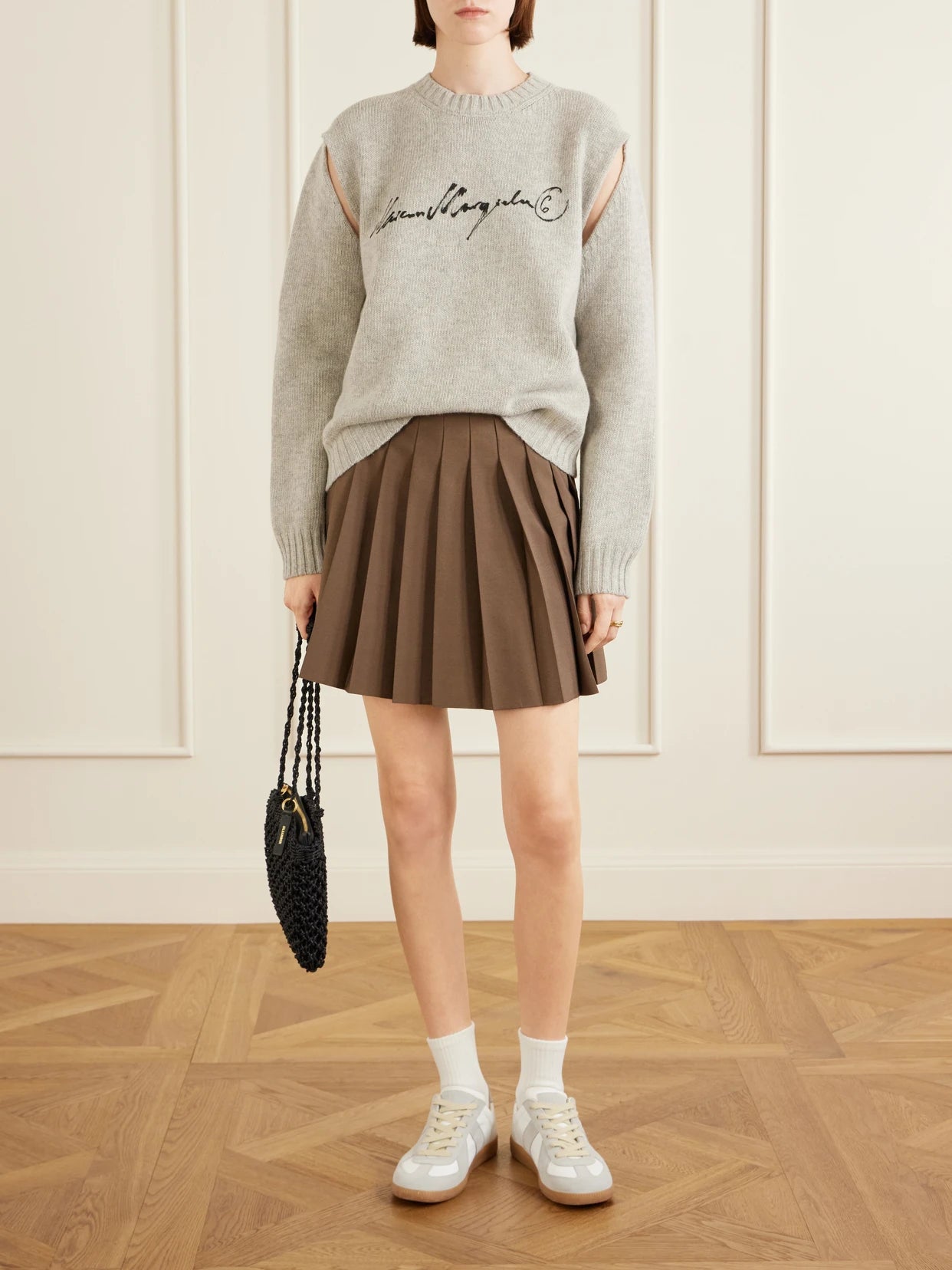 Image of a model wearing Outerwear. Product name - Logo-print Cut-out Wool-blend Sweater in Light gray colour by brand - MM6 MAISON MARGIELA