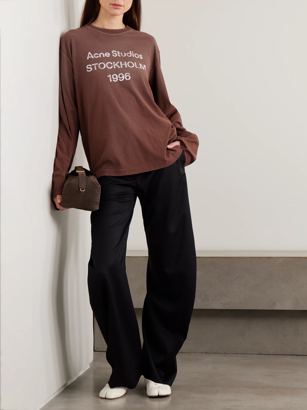 Image of a model wearing Tops. Product name - Oversized Printed Organic Cotton And Hemp-blend Jersey T-shirt in Brown colour by brand - Acne Studios